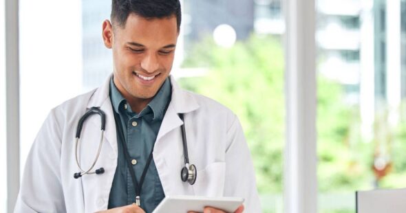 smiling doctor with tablet